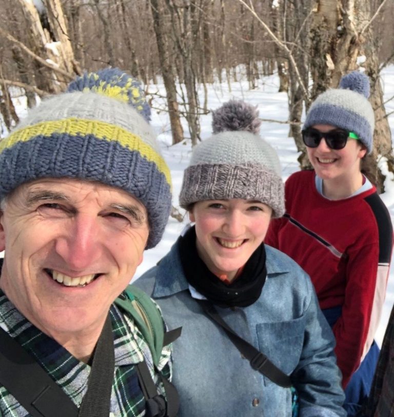 Photo of Brian, Kate, and Lucy McKay in the winter woods