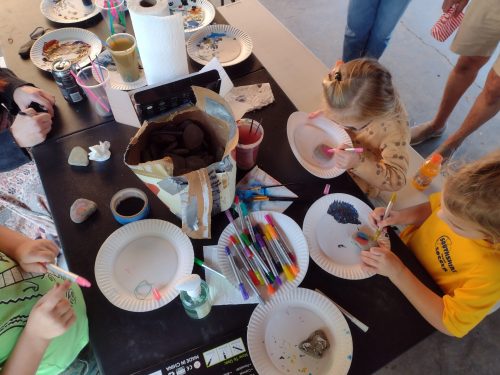 Photo from above of children doing a painting craft activity